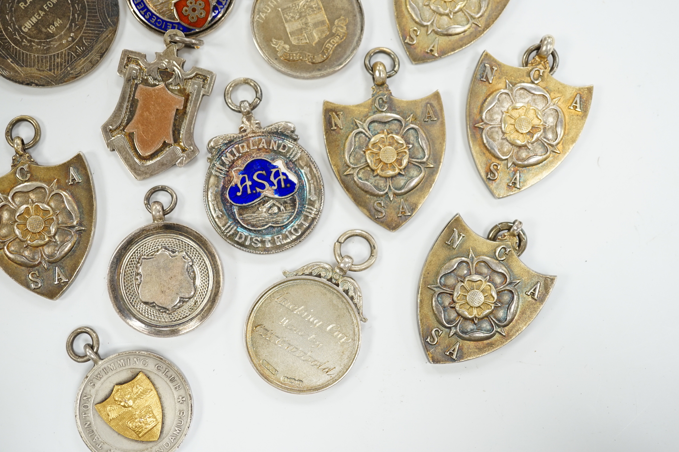 Twelve assorted mainly mid 20th century silver medals, including running and swimming (three with enamel) and two other white metal medals.